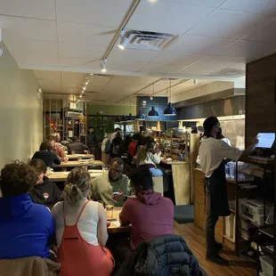 people sitting at tables in a restaurant