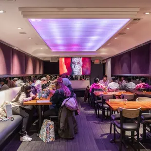 a large group of people eating in a restaurant