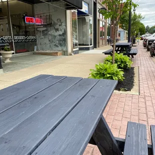 Picnic benches out front for sidewalk dining