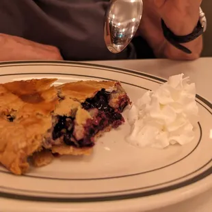 Hot blueberry pie with whipped cream