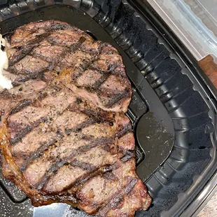 Hair on top right of steak