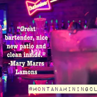 a neon sign and a drink