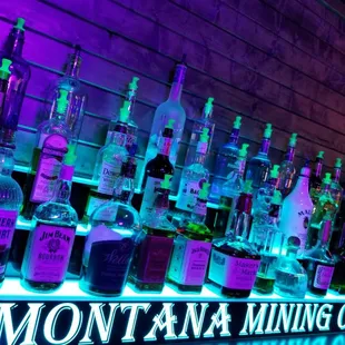 bottles of liquor lined up on a shelf