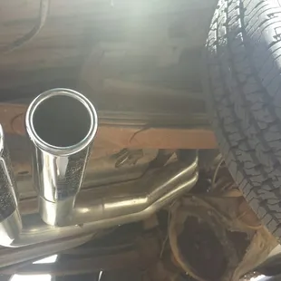 Slightly offset duals out behind rear wheel w chrome tips- at Montana Muffler.