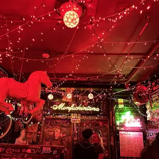 a bar with red lights and decorations