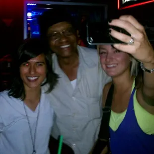 three women and a man taking a selfie