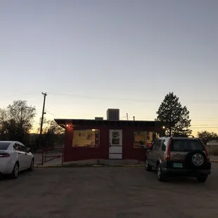 two cars parked in front of the restaurant