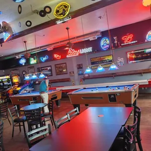 a pool table and neon signs