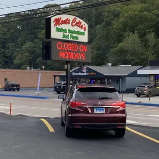 a car parked in front of a closed sign