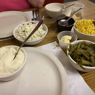 Mashed potatoes, cole slaw, corn, green beans, gravy, and mystery sweet jam?