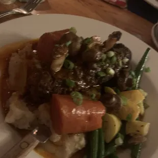 Below cooked Bison ribs with perfect veggies and delish sauce which ribs was braised!