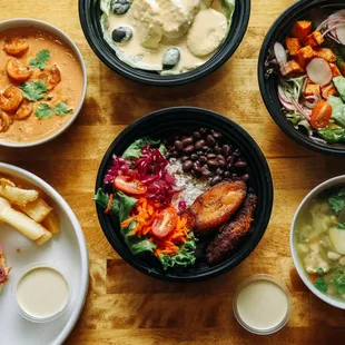 four bowls of food on a wooden table