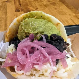 close up of the beans, avocado, and pickled onion topping choice.