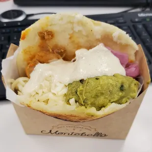 Chicken Arepa with avocado and pickled onions as toppings accompanied with a delicious sauce.