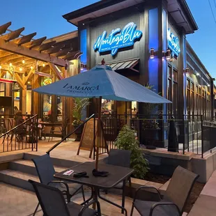 a patio area with tables and chairs