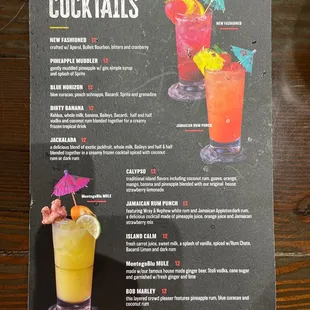 a cocktail menu on a wooden table