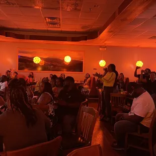 a crowd of people sitting at tables