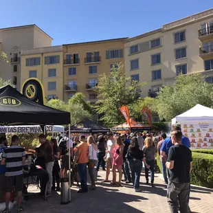 a crowd of people standing under a tent