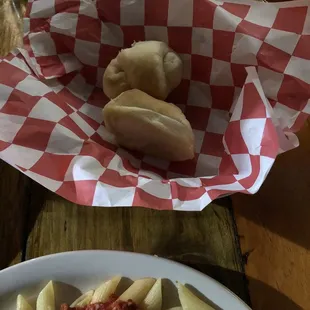 One small roll per person. It didn't have or provided any butter or garlic spread.