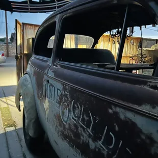 an old car with graffiti on it