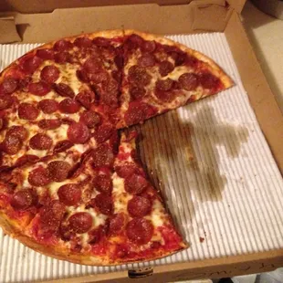 a half eaten pepperoni pizza