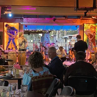 a group of people sitting at tables in a restaurant