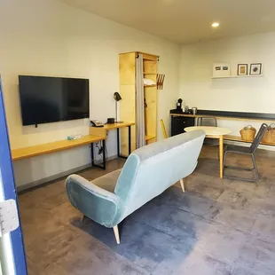 Livingroom with large TV with cable and comfy sofa