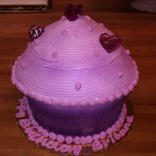 two decorated cupcakes on a table