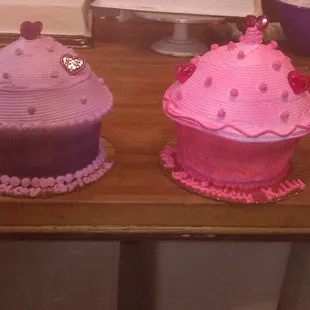 two decorated cupcakes on a table