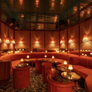 a seating area with candles on the tables