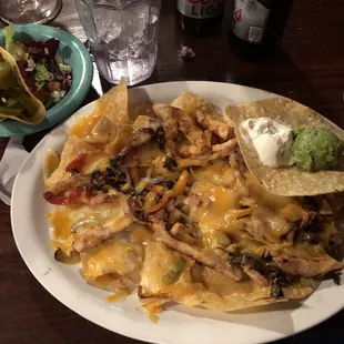 a plate of nachos and a salad