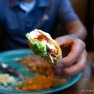 a person eating a burrito