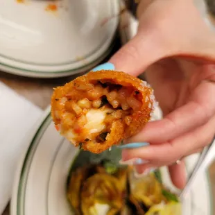 a person holding a piece of food