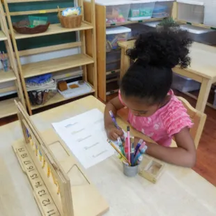 Using the hanging bead stair (teens), this pre-school aged friend works on understanding number quantities.