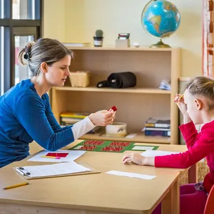 This Montessori Guide gives an individualized lesson to this elementary student.