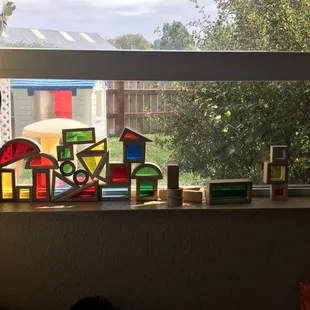 Color blocks highlight the sunshine in the toddler room, looking out onto the toddler play area - children spend time outside daily