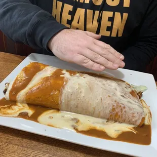Hand to show how massive the California burrito is.