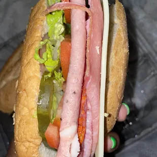 a person holding a sandwich