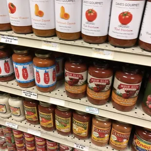 A lot of pasta sauces for a small corner store market