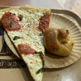 a slice of pizza on a paper plate