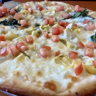 a pizza with tomatoes and artichokes