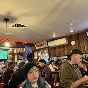 a group of people sitting at a bar