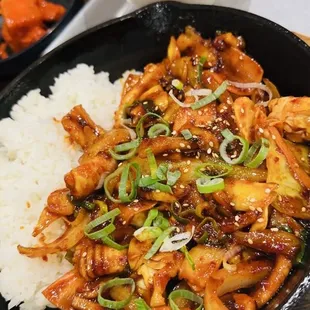 Stir fry spicy squid served with a bowl of soup and side rice