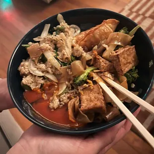 From left, basil rice with beef, fried dumplings, pad see ew with tofu... Plus a pond of Sriracha.