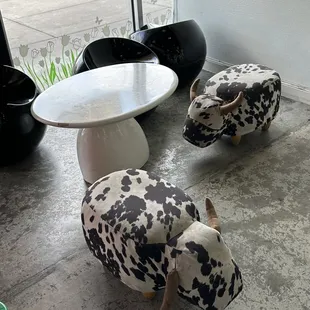 two cow chairs and a table
