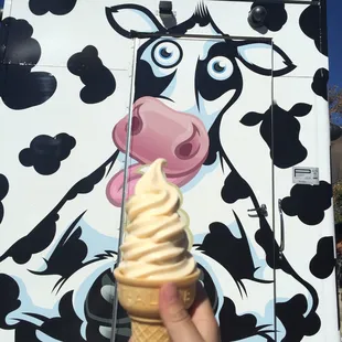 a hand holding an ice cream cone