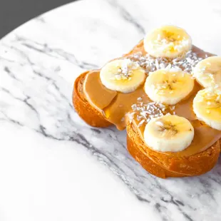 Croissant Toast- The Number One: peanut butter, banana, coconut flakes, cinnamon, honey.