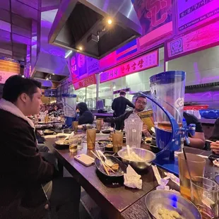 a group of people eating at a restaurant
