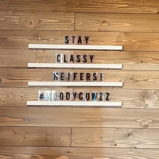 a wood paneled wall with letters