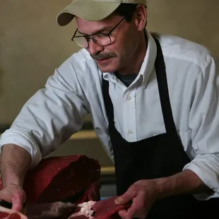 a man cutting meat